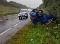 Car ends up on roof in heavy rain on A38