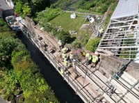 Builders working hard to mend wall and re-open road 