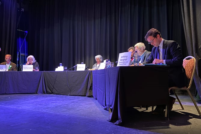 The speakers preparing for the start of the debate