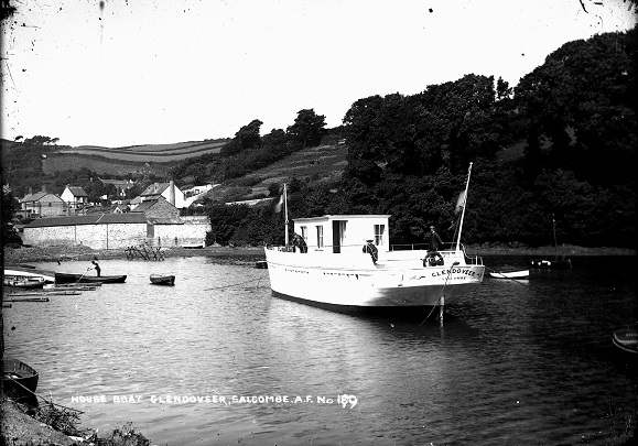 Caption:" Houseboat Glendoveer, Salcombe. A.F. No. 189". 1900 = 1920. Moored Shadycombe Creek but taken astern of Glendoveer looking up towards head of creek. Small boats moored/beached on left.