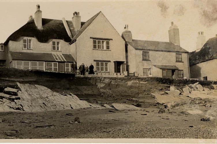 Three villagers surveying beach at Torcross after defence wall was blown down during storm on 21.12.1951