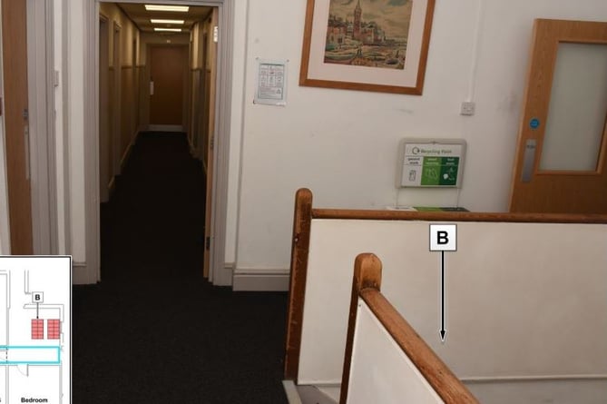 A view of the second floor corridor and stairwell, indicated by B.
