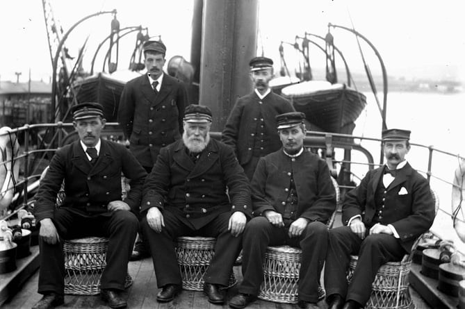 Captain and officers of a passenger steamer. All seated on deck.