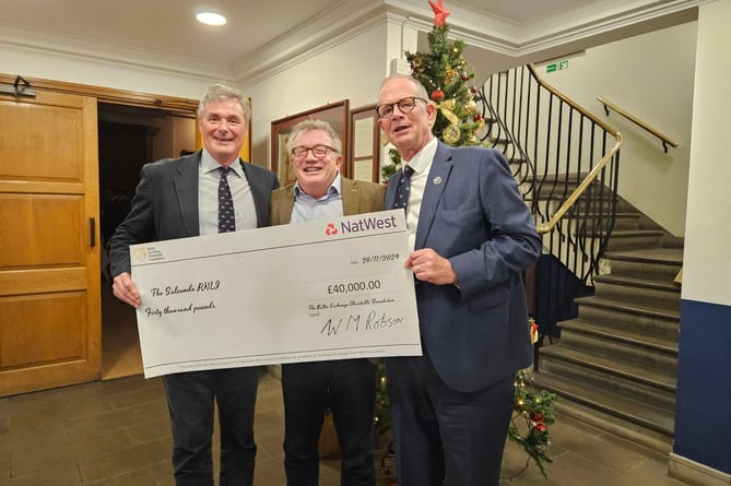 L to R: Chief Executive of the Baltic Exchange Mark Jackson, Bruce Munroe and Chairman of Salcombe RNLI Philip Ward