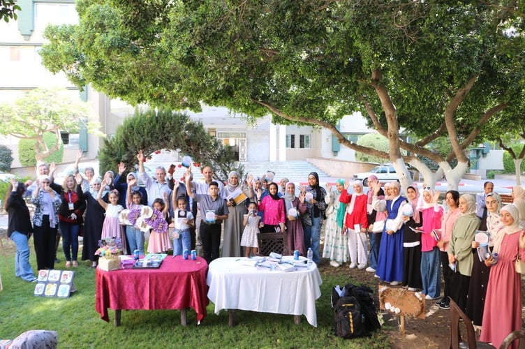 Bilbrough and Hands Up volunteers joined by Palestinian teachers and children in a group shot, taken in 2023 outside the Islamic University of Gaza. It now lies in ruins